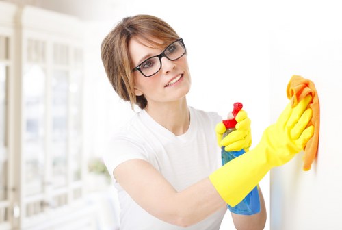 Professional cleaners maintaining shared desks in an Islington co-working space